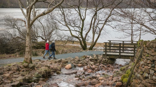 Visitors crossing a bridge on their circular walk around the lake Buttermere, Lake District
